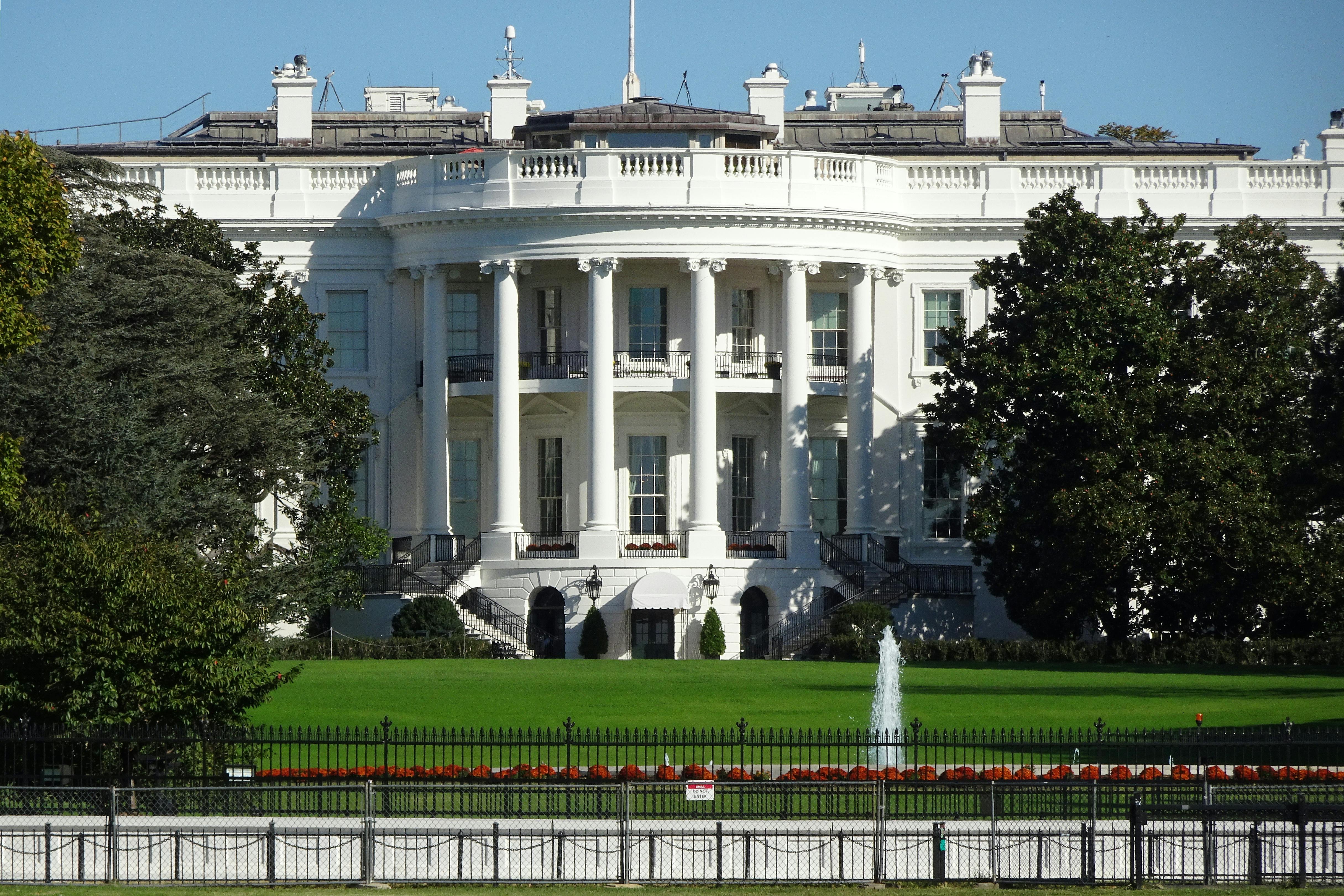 Front view of the White House North Portico in Washington, with lawn and central fountain