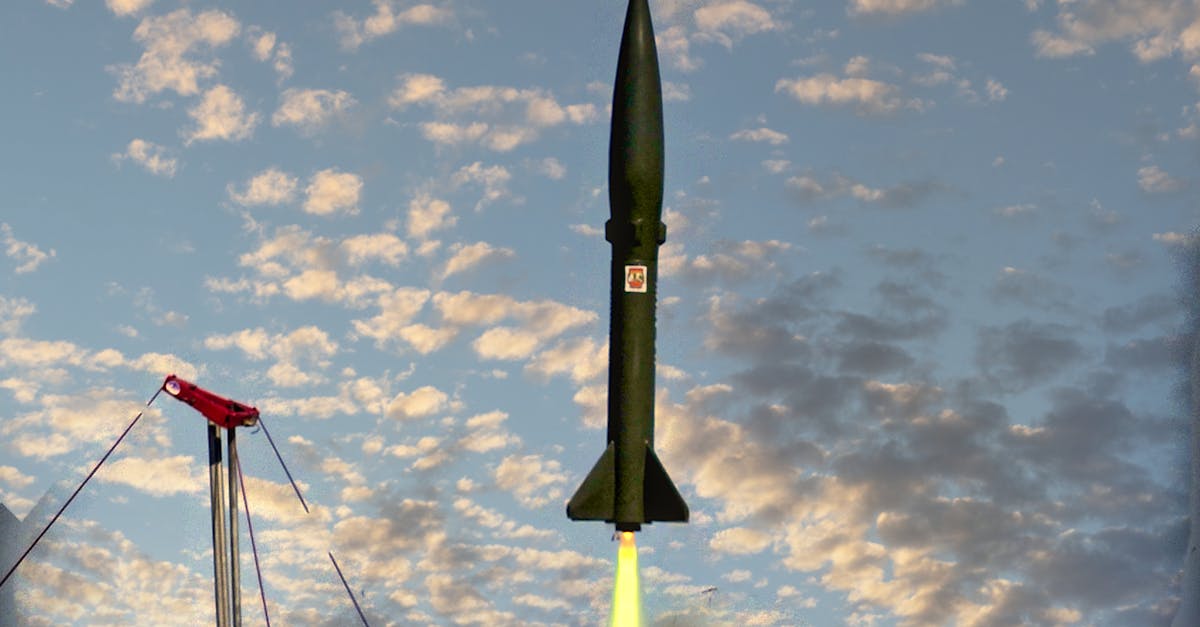 A military missile launches skyward leaving a trail of smoke against the sunset