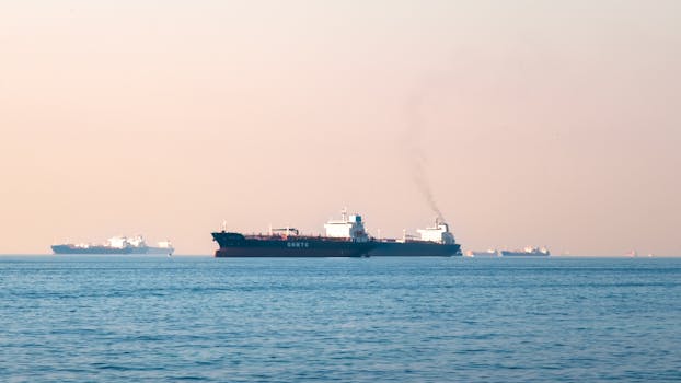 Industrial tanker ships navigating the open sea near the Strait of Hormuz