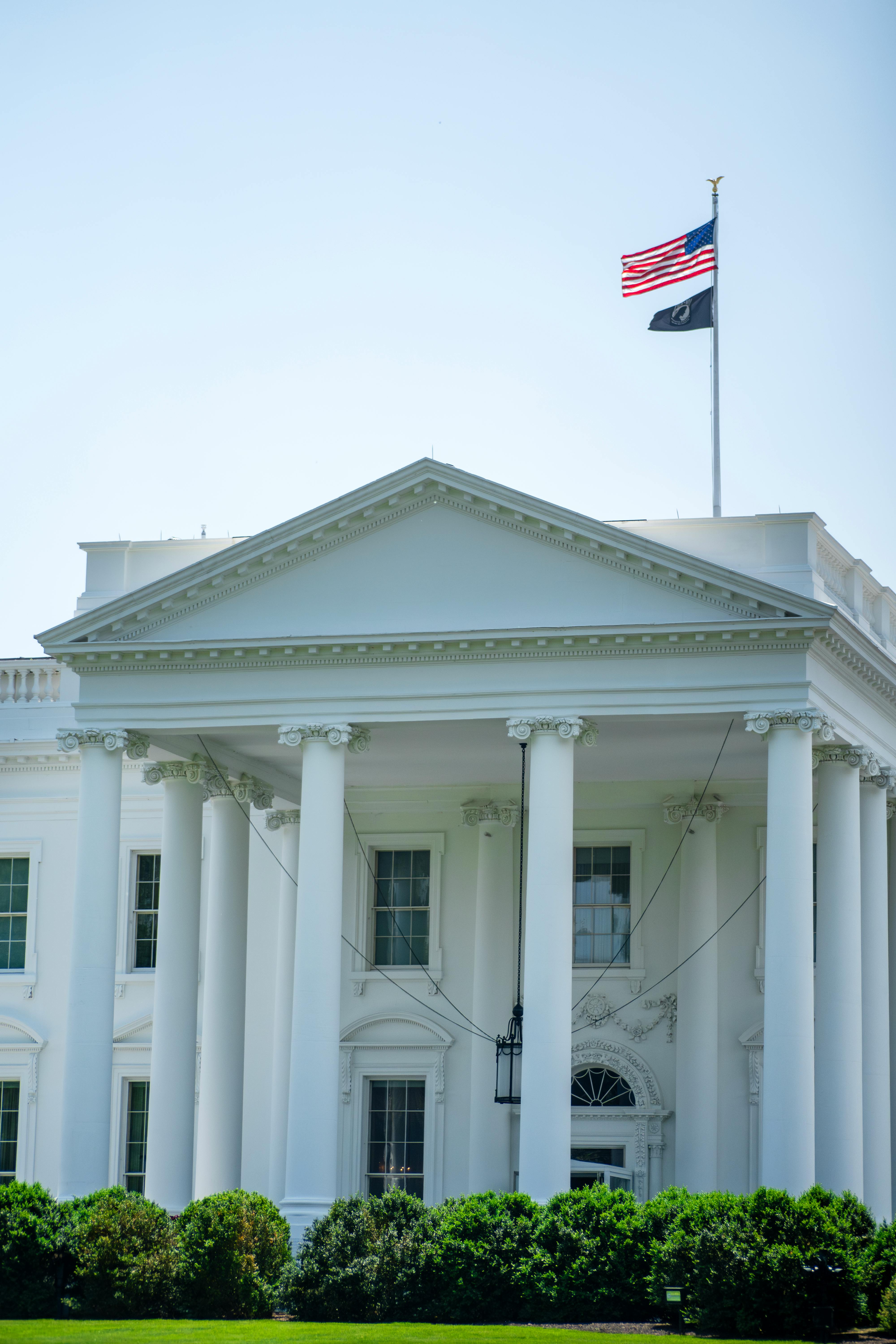 White House exterior with American flag on a sunny day, Washington D.C.