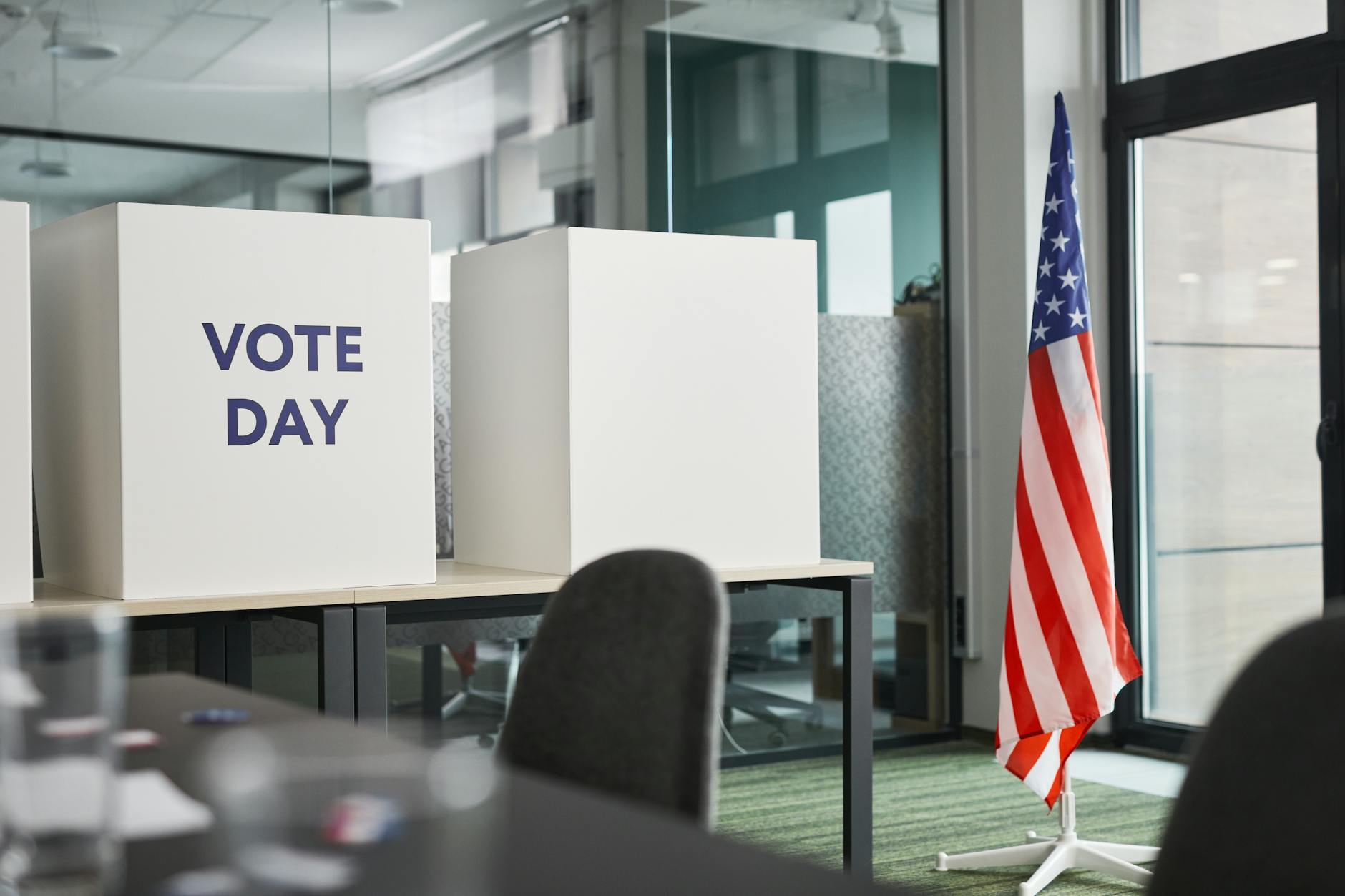 American flag and voting boxes set up in a polling station for an upcoming election