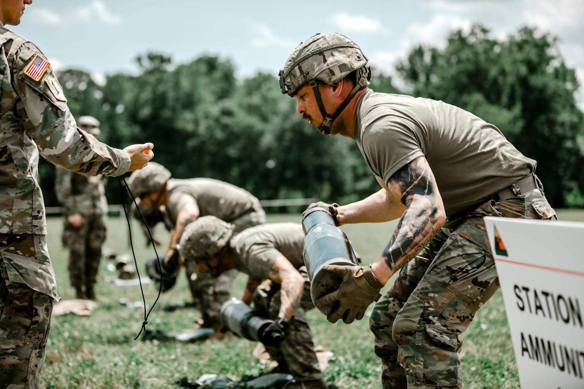 US Army soldiers in camouflage uniforms during an outdoor training exercise at Fort Benning
