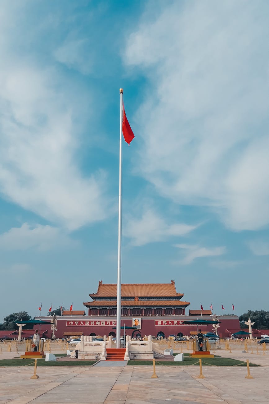 Tiananmen Square in Beijing with the Chinese national flag against a clear blue sky
