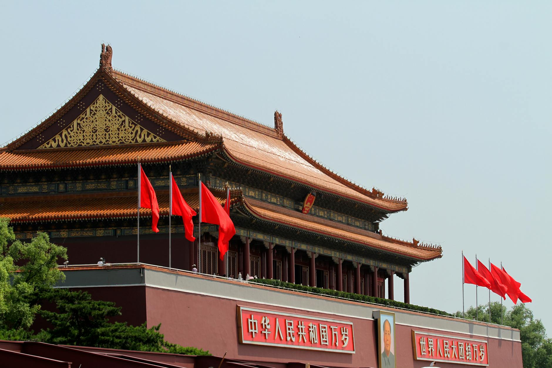 Tiananmen Gate in Beijing with red flags under clear sky