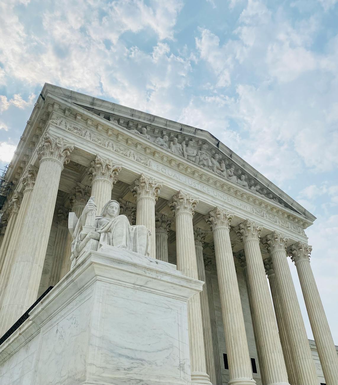 A low angle shot of the US Supreme Court showcasing its grandeur and architectural detail
