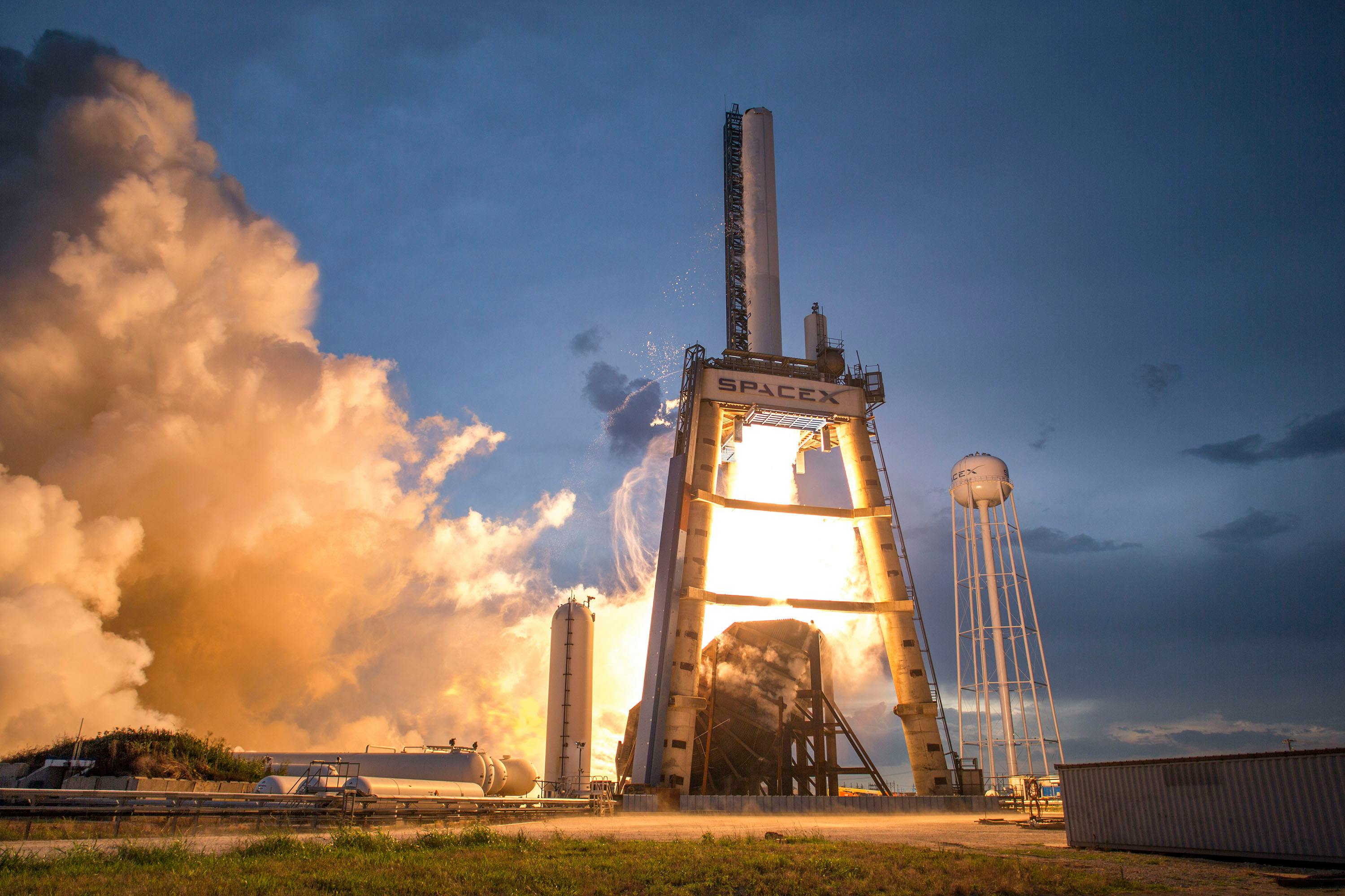 A dramatic shot of a SpaceX rocket launch against a colorful dusk sky
