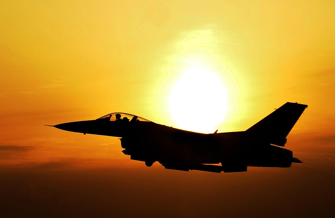 Fighter jet in flight during sunrise