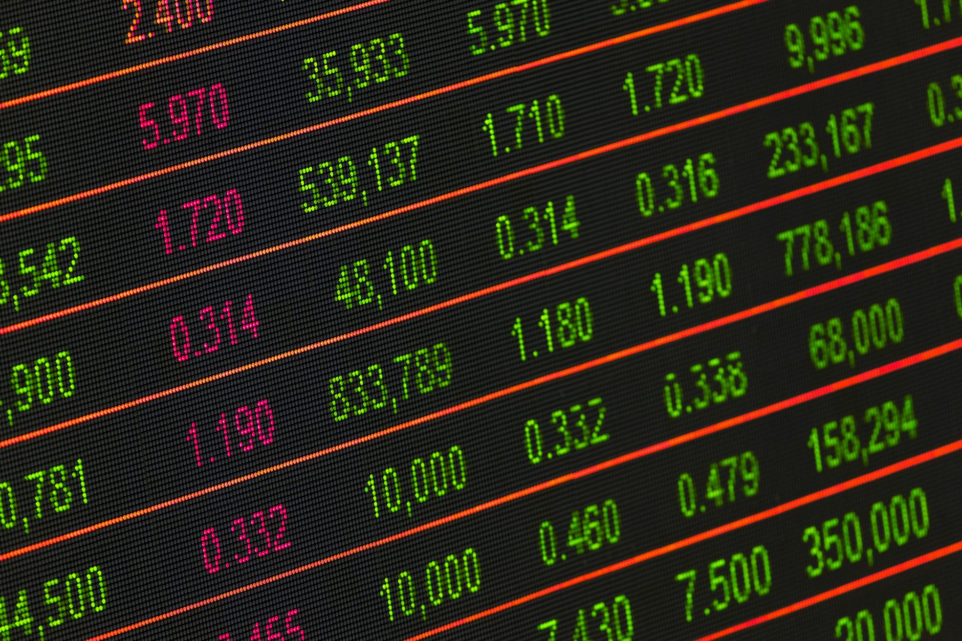 Close-up of a digital stock market data display showing colorful financial numbers and trends