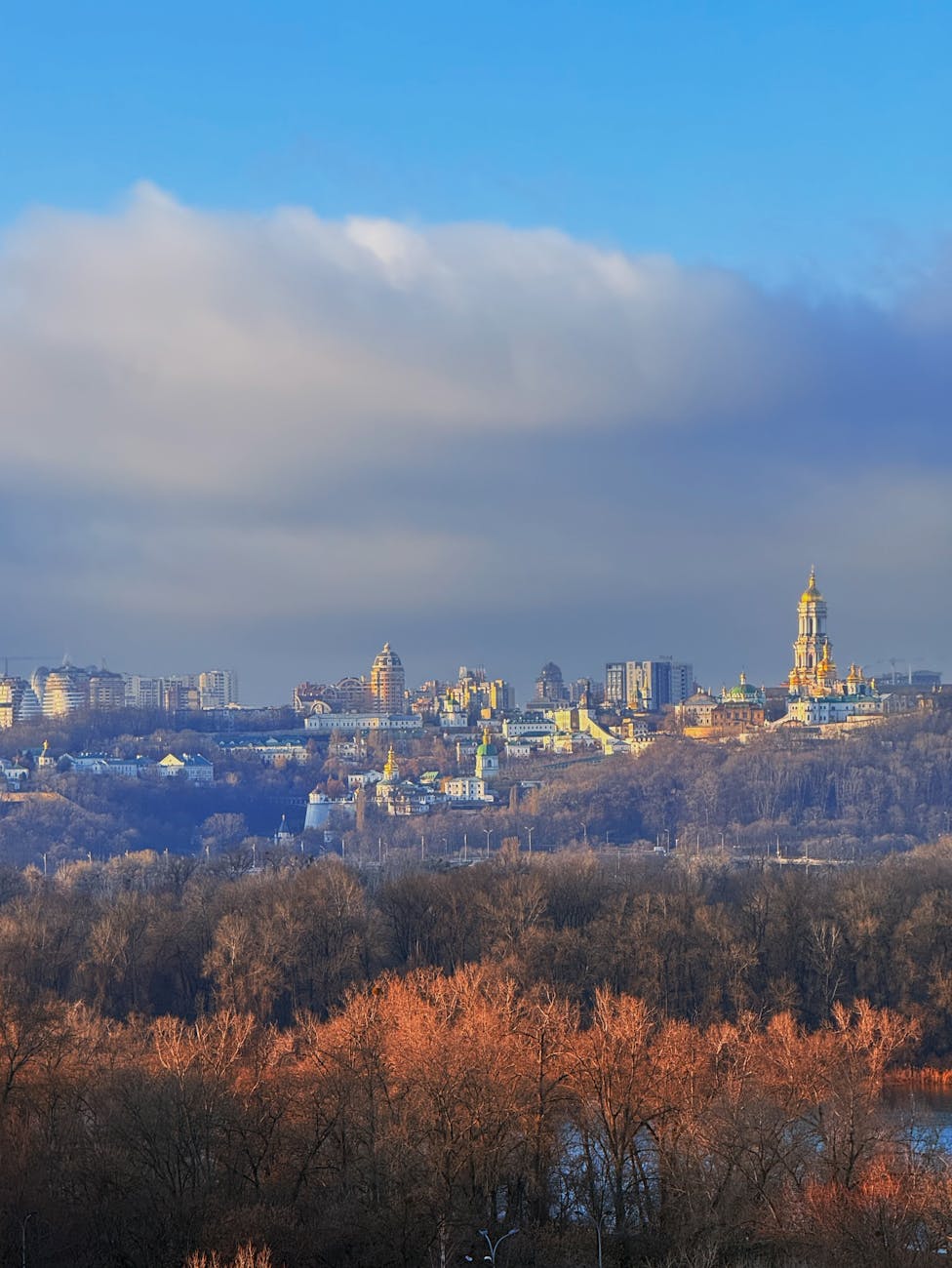 Breathtaking skyline view of Kyiv, Ukraine capturing iconic landmarks under a vibrant sky.