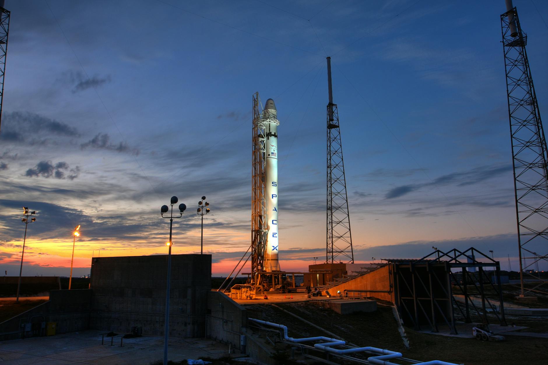 SpaceX rocket on launch pad at sunset