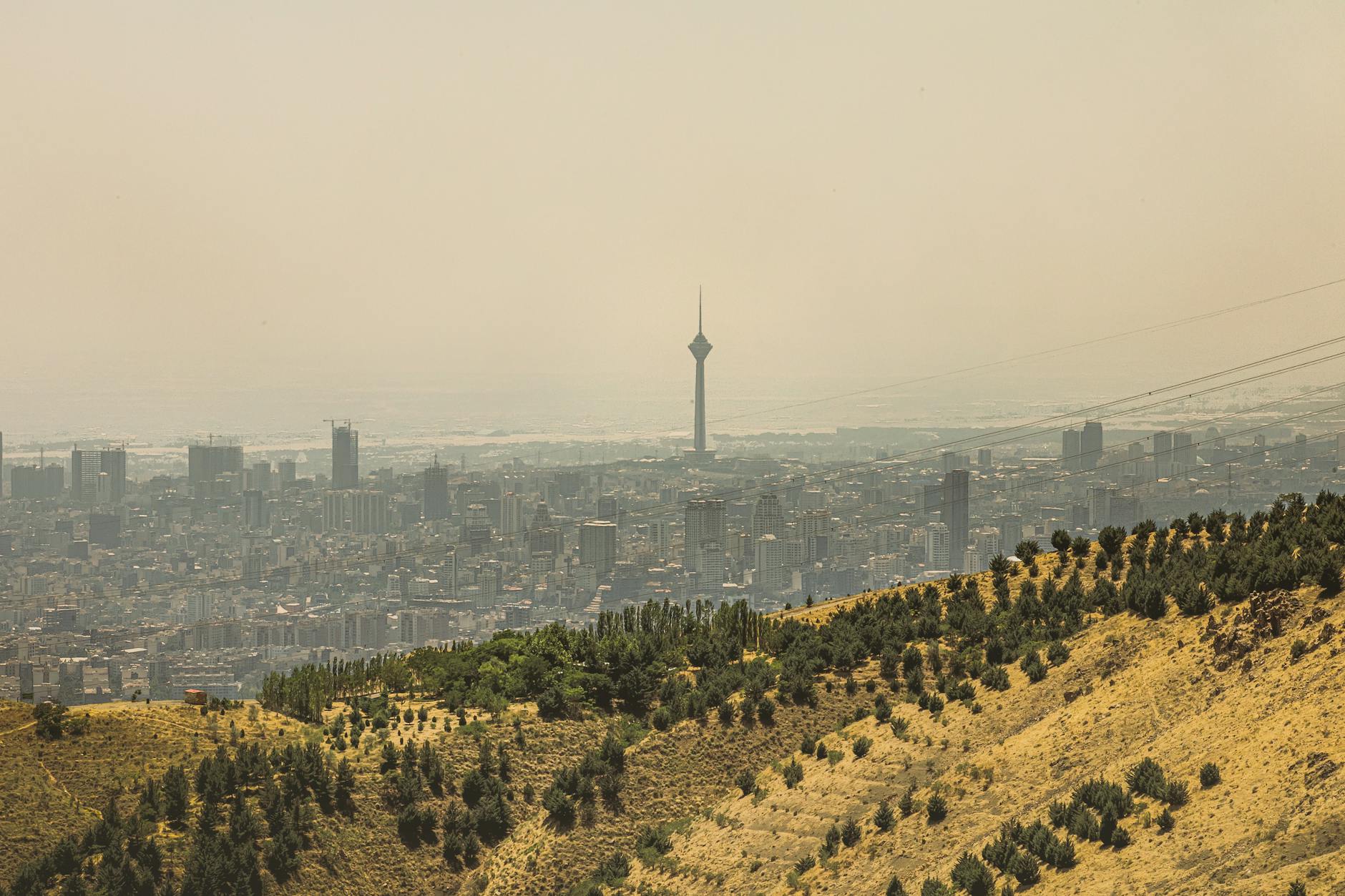 Tehran skyline at dusk with mountains in the background