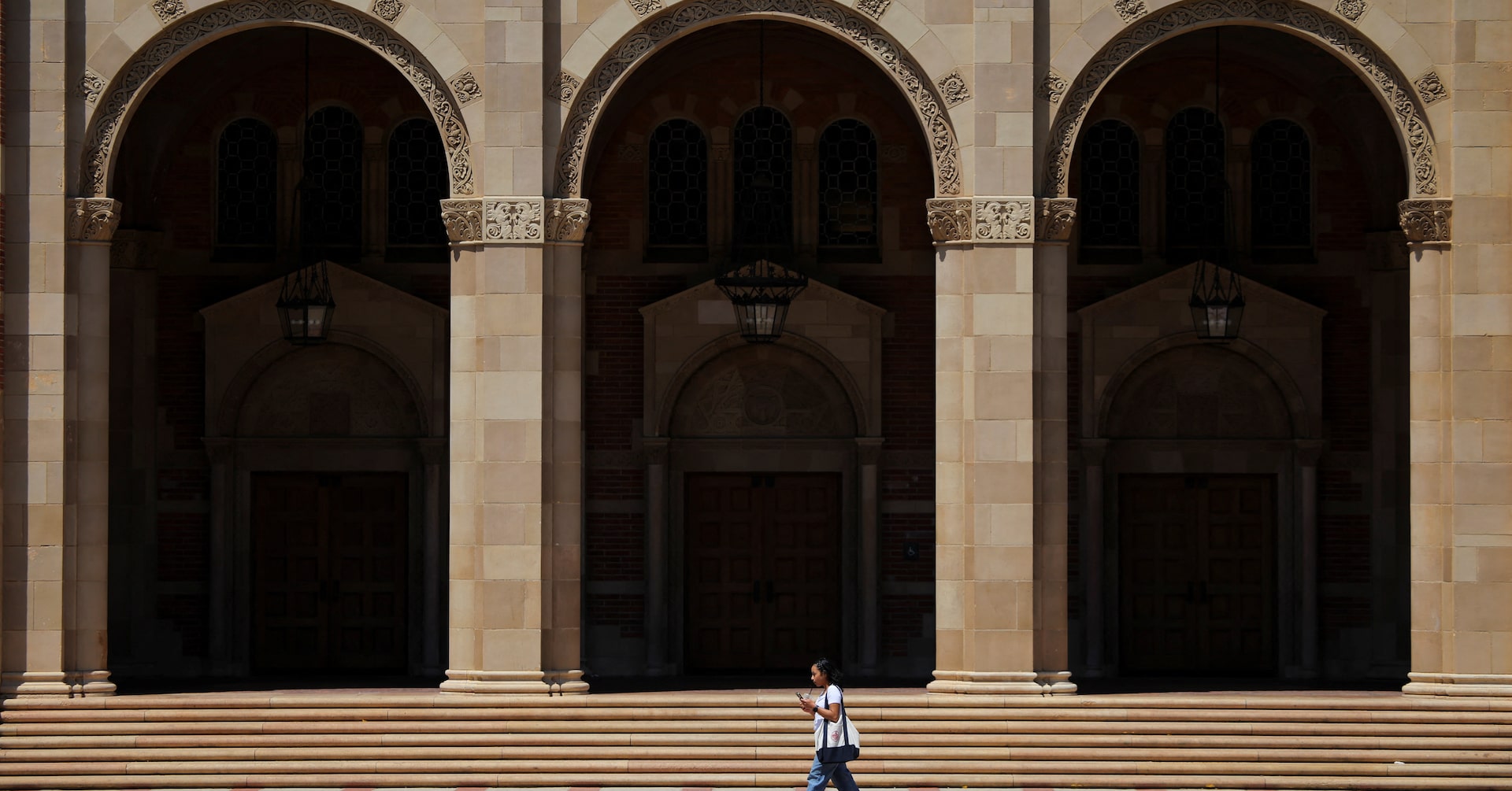 A woman walks by Royce Hall at the University of California Los Angeles (UCLA) in Los Angeles, California, U.S., August 11, 2025.