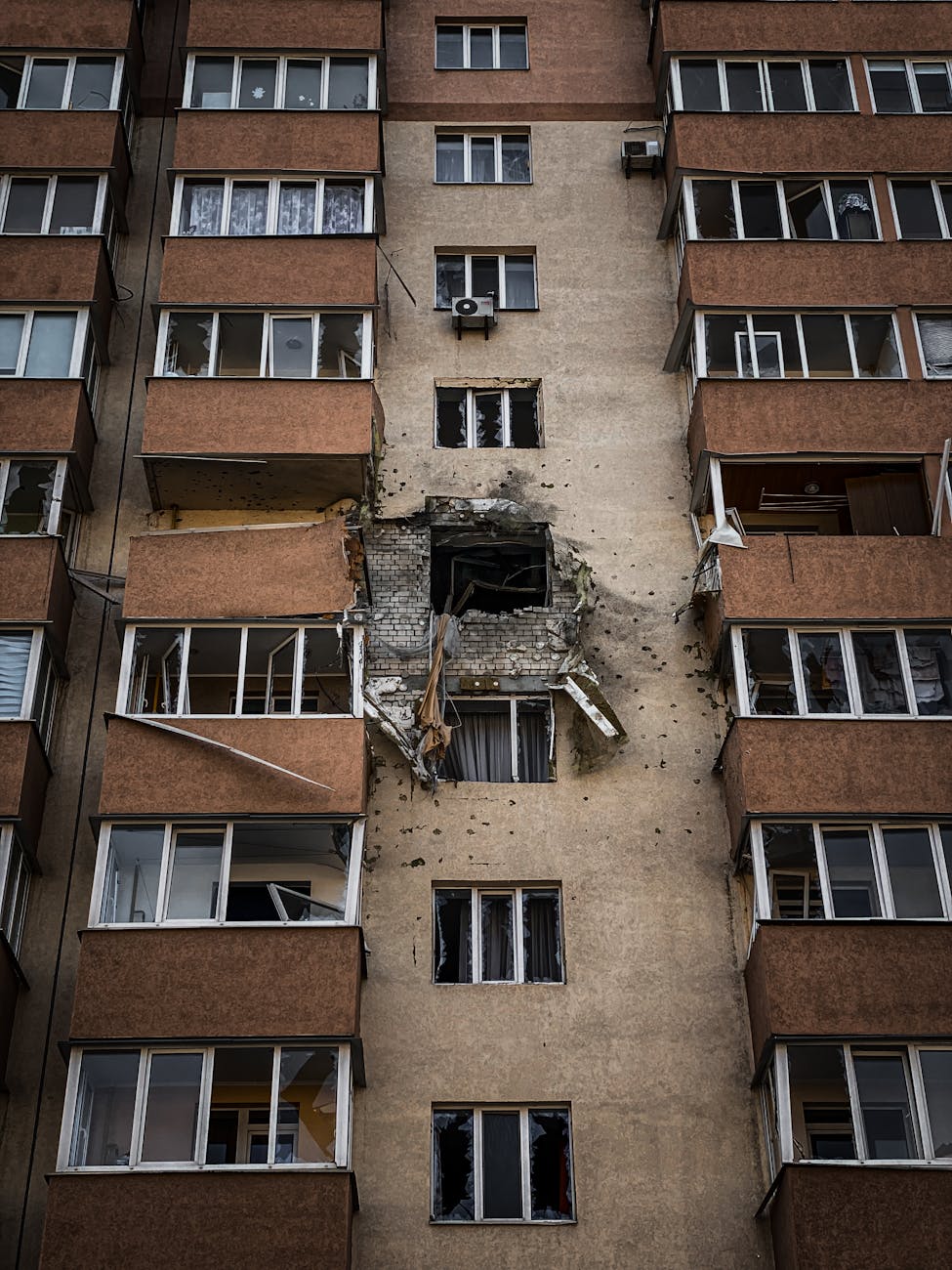 Urban apartment building facade with visible war damage