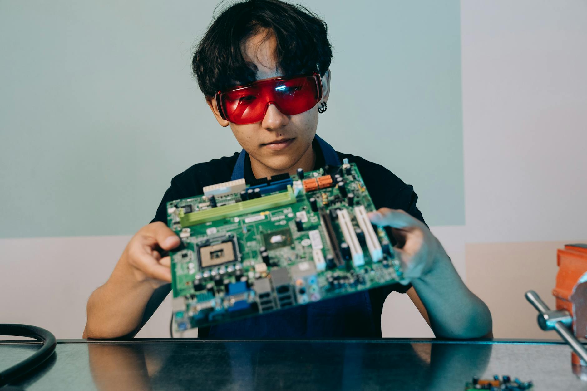 Engineer holding a circuit board as AI competition shifts toward technical talent