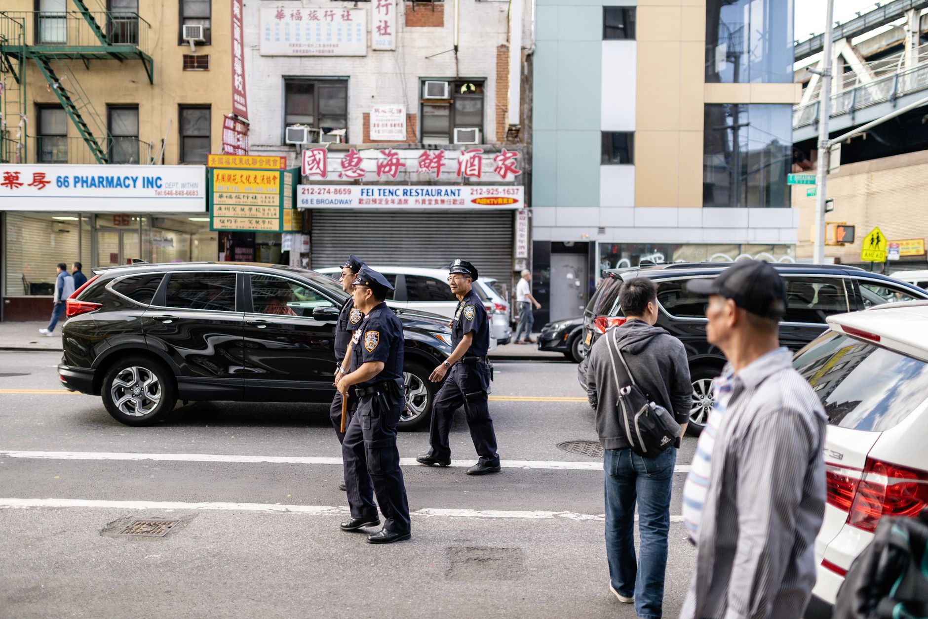 Police officers walk through an urban Chinatown street as US authorities scrutinize alleged Chinese influence operations.
