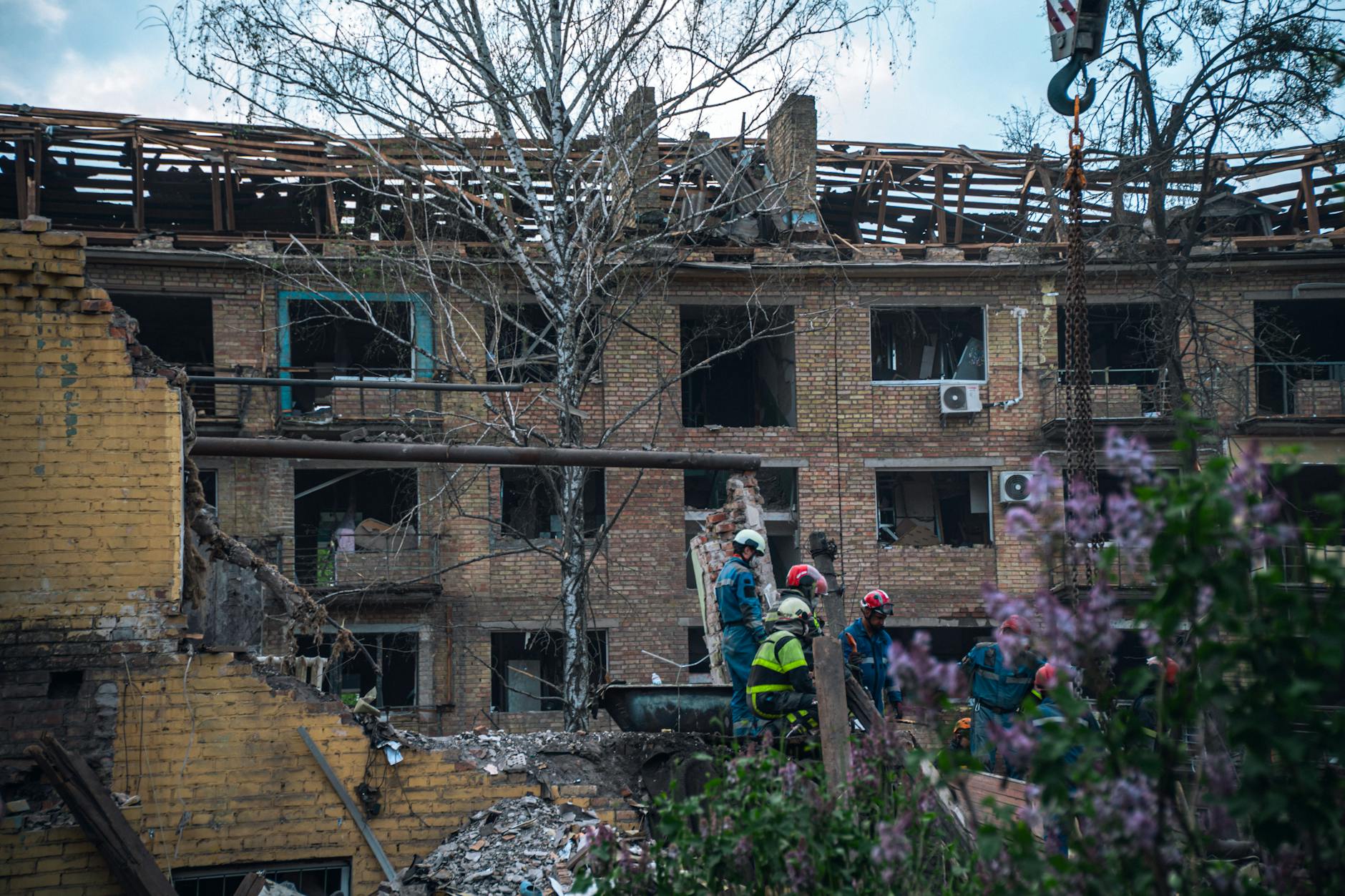Firefighters inspect a damaged building in Kyiv after a Russian attack.