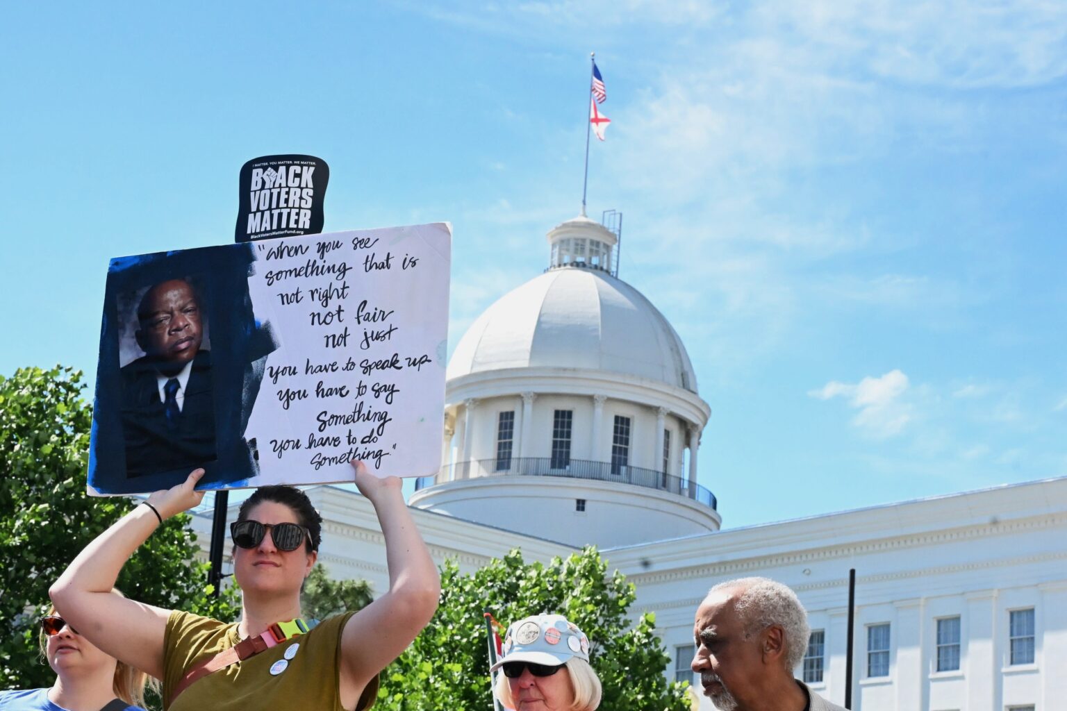 Protest sign outside the Alabama State Capitol during a redistricting demonstration in Montgomery